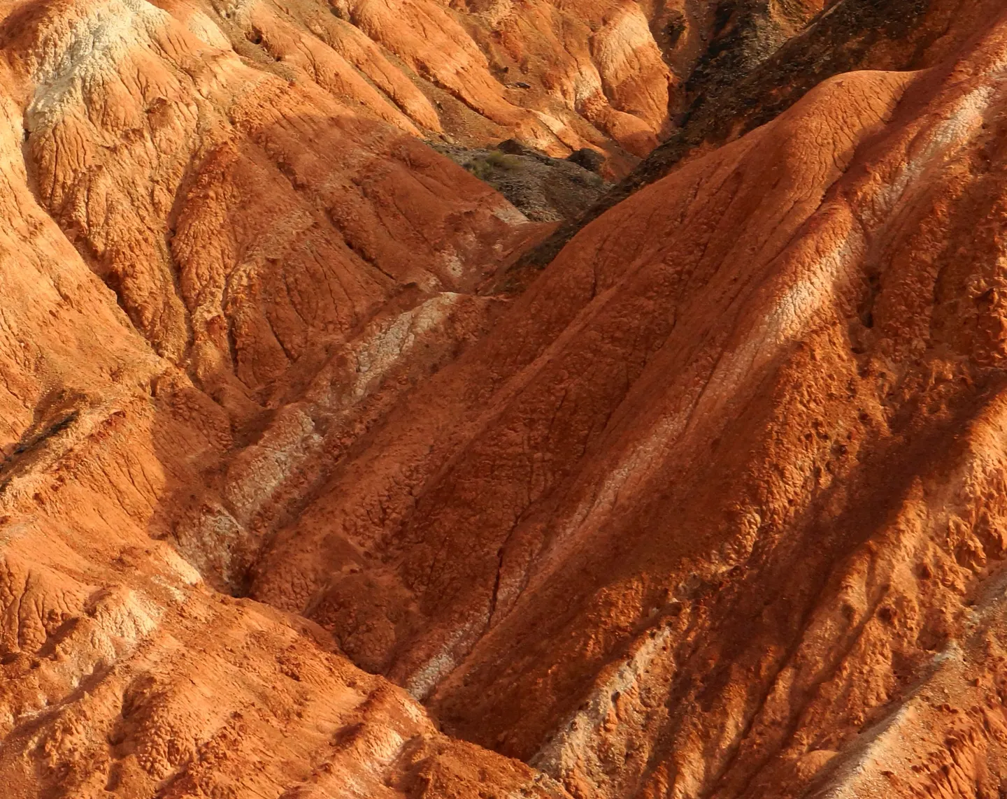 Fragment of red and ochre layered hills.